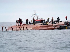 Divers work aboard the Danish cargo ship Karin Hoej which collided with the British cargo ship Scot Carrier between Ystad and Bornholm, on the Baltic Sea December 13, 2021.