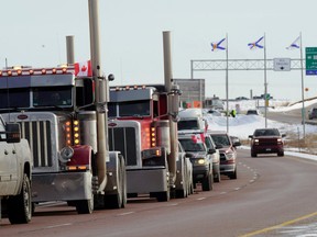 Truck drivers protesting against coronavirus disease (COVID-19) vaccine mandates drive in a convoy on the Nova Scotia/New Brunswick provincial boundary in Fort Lawrence, Nova Scotia, Canada, January 23, 2022.