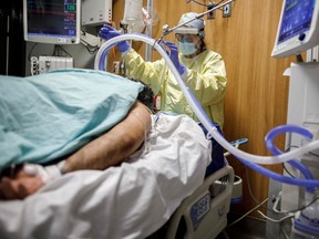 Respiratory Therapist Flor Guevara adjusts a breathing tube for a patient suffering from coronavirus disease (COVID-19) at Humber River Hospital's Intensive Care Unit, in Toronto, Ontario, Canada, on April 29, 2021.