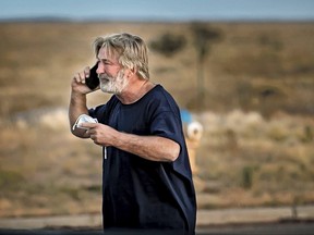 Alec Baldwin speaks on the phone in the parking lot outside the Santa Fe County Sheriff's Office in Santa Fe, N.M., after he was questioned about a shooting on the set of the film "Rust" on the outskirts of Santa Fe, Thursday, Oct. 21, 2021.