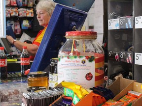 A Lancaster Food Bank cash donation jar sits near the cash register of a gas station in Lancaster, Ont., Nov. 14, 2021.