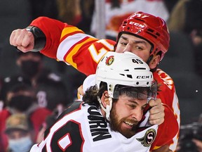 Milan Lucic #17 of the Calgary Flames fights Scott Sabourin #49 of the Ottawa Senators on Thursday night.