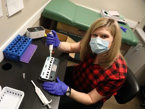 Nurse Melissa Hall processes a COVID-19 test at Bridlewood Medical Centre in Kanata. The clinic offers same day test results for $225.