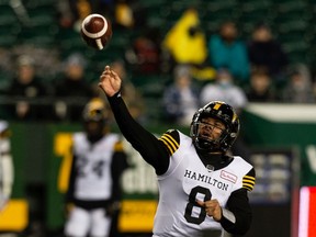 Hamilton Tiger-Cats' quarterback Jeremiah Masoli (8) throws the ball past Edmonton Elks' Mathieu Betts (9) during first half CFL action at Commonwealth Stadium in Edmonton, Oct. 29, 2021.