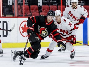 -OTTAWA-  Ottawa Senators centre Josh Norris (9) and Carolina Hurricanes centre Sebastian Aho (20) during first period NHL action at the Canadian Tire Centre on Jan. 27, 2022.