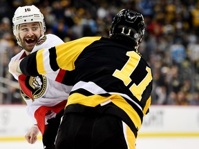 Austin Watson of the Ottawa Senators and Brian Boyle of the Pittsburgh Penguins fight during Thursday's game.