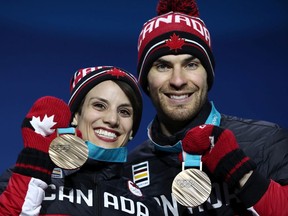 Eric Radford, seen with former partner Meagan Duhamel on the podium at the 2018 Winter Olympic Games, says COVID-19 looms as an 'invisible minefield' for all athletes who are headed to the Beijing Games.
