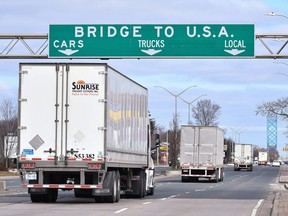 Transport trucks approach the Canada-U.S. border crossing in Windsor, Ont. in this file photo from March 2020.