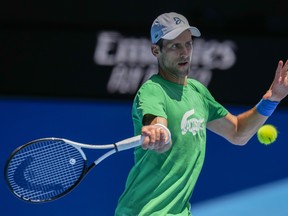 Defending men's champion Serbia's Novak Djokovic practices on Margaret Court Arena ahead of the Australian Open tennis championship in Melbourne, Australia, Thursday, Jan. 13, 2022.