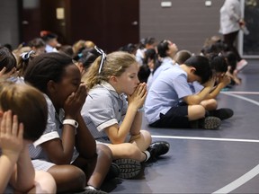 Students at Citipointe Christian College in Brisbane, Australia appear to be in prayer.