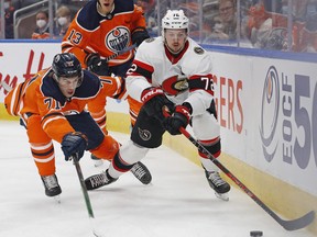 Ottawa Senators defencemen Thomas Chabot (72) and Edmonton Oilers forward Ryan McLeod (71) chase a loose puck during the first period at Rogers Place on Saturday, Jan. 16, 2022.