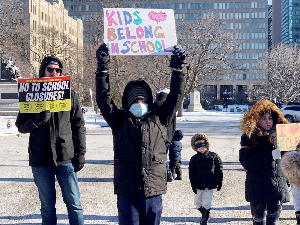 Parents demanding the re-opening of schools protest outside the Ontario legislature of Queen's Park in Toronto January 3, 2022.