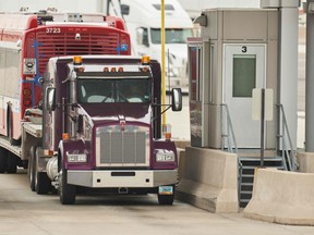 A trucker waits at the Canada Customs booth and the US/Canada border in Sarnia, Ontario on March 16, 2020.