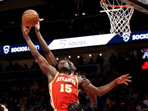 Atlanta Hawks centre Clint Capela (15) and Toronto Raptors forward Chris Boucher (25) fight for a rebound during the second quarter at State Farm Arena.