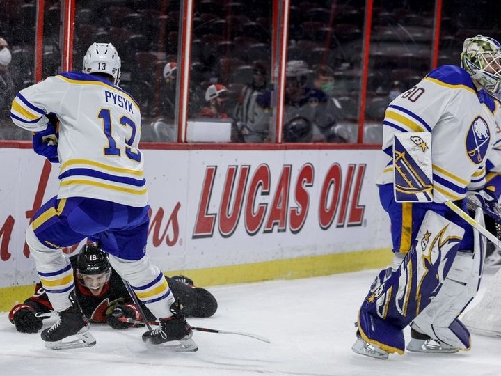  Ottawa Senators right wing Drake Batherson (19) hits the end boards after being hit by Buffalo Sabres goaltender Aaron Dell (80) during the first period at the Canadian Tire Centre on Tuesday night.