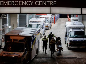 An ambulance crew members walk through the ambulance bay.