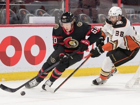 Senators defenceman Lassi Thomson (60) skates with the puck in front of Ducks centre Derek Grant (38) in the first period of Saturday's game.