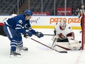 Toronto Maple Leafs centre John Tavares (91) looks for the rebound as Ottawa Senators goaltender Matt Murray (30) makes the save during the third period at Scotiabank Arena.