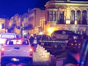Police forces work at the scene as they remove a vehicle with bodies that were left by unknown assailants in front of the Government Palace, in Zacatecas, Mexico on Jan. 6.