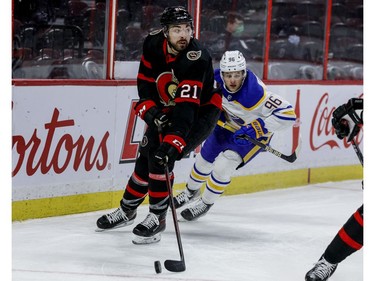 Ottawa Senators left wing Nick Paul (21) looks up ice with Buffalo Sabres left wing Anders Bjork in pursuit.