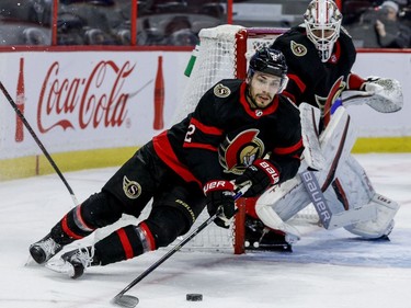 Ottawa Senators defenceman Artem Zub (2) clears the puck as Ottawa Senators goaltender Matt Murray (30) looks on during the second period.