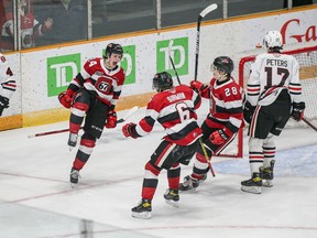 Vinzenz Rohrer of the 67's celebrates with Thomas Sirman and Vsevelod Gaidamak after scoring the overtime winning goal against the IceDogs.