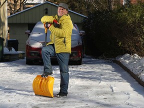 Postmedia reporter Kelly Egan with his snow shovel outside his house in Ottawa.