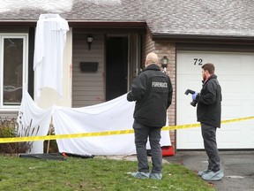 A Nov. 15 photo shows the Ottawa Police Service Homicide Unit investigating the scene at a house on Sherway Drive in Barrhaven.