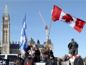 A Canadian flag flies upside down at Parliament Hill on Friday, Jan. 28, 2022.