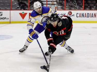 The Ottawa Senators' Tim Stuetzle (18) battles Buffalo Sabres defenceman Mattias Samuelsson.