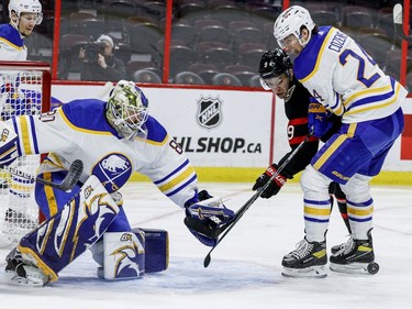 Ottawa Senators centre Josh Norris (9) battles Buffalo Sabres centre Dylan Cozens for a rebound in front of goaltender Aaron Dell in the first period.