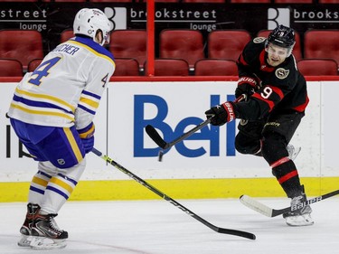 Ottawa Senators centre Josh Norris (9) shoots past Buffalo Sabres defenceman Will Butcher (4) during the first period.