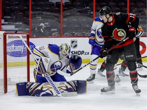 Ottawa Senators right wing Drake Batherson looks on in front of Buffalo Sabres goaltender Aaron Dell (80) as the puck rings off the crossbar during the first period.