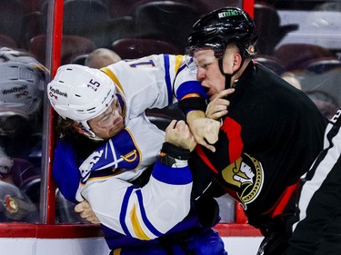 Ottawa Senators left wing Brady Tkachuk (7) fights Buffalo Sabres centre John Hayden (15) during the first period.