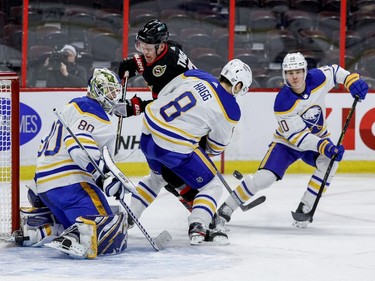 Ottawa Senators left wing Brady Tkachuk (7) battles Buffalo Sabres defencemen Robert Hagg (8) and Henri Jokiharju (10) in front of Sabres goaltender Aaron Dell.