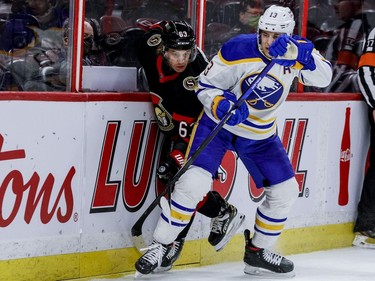 Ottawa Senators right wing Tyler Ennis (63) attempts to get past Buffalo Sabres defenceman Mark Pysyk along the boards.