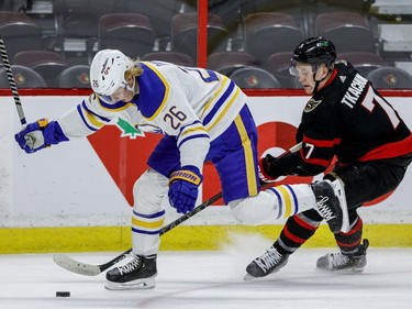 Ottawa Senators left wing Brady Tkachuk (7) and Buffalo Sabres defenceman Rasmus Dahlin battle for possession of the puck.