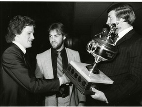 Randy Boyd, middle, and Randy Cunningworth and Randy Boyd accept the 67's team MVP trophy from one of the owners.