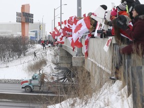 Hundreds of people lined the Bass Pro Mills Dr. over Hwy. 400 to cheer on truckers. A couple thousand protestors/supporters were on hand at Vaughan Mills shopping centre to show their support for a large group of truckers taking part in the anti-vaccination Canada-U.S. border mandate on Thursday, Jan. 27, 2022.