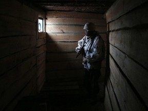 An Ukrainian serviceman attends in a dugout on the frontline with the Russia-backed separatists near Avdiivka, Donetsk region, on February 2, 2022.