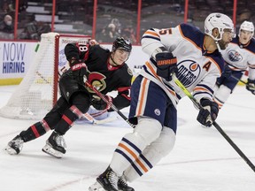 Senators left wing Tim Stuetzle (18) pursues Edmonton Oilers defenseman Darnell Nurse (25) during first period NHL action at the Canadian Tire Centre on January 31,2022.