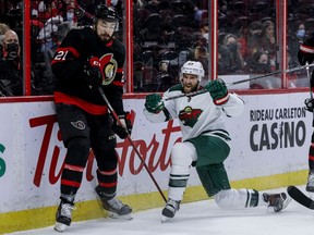 Ottawa Senators left wing Nick Paul (21) and Minnesota Wild defenseman Alex Goligoski (47) during first period NHL action at the Canadian Tire Centre. February 22,2022.