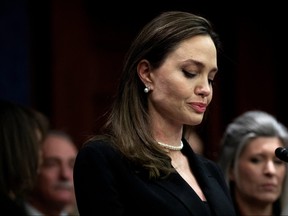 Actor Angelina Jolie speaks beside members of Congress on the Violence Against Women Act, on Capitol Hill in Washington, Feb. 9, 2022.