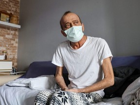 Muzaffer Kayasan, a Turkish man who has taken 78 COVID-19 tests and every one has come back positive, leaving him isolated from his family for 14 straight months, rests at his home in Istanbul, Turkey, Thursday, Feb. 10, 2022.