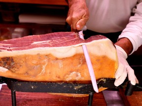 A grocer slices prosciutto ham in a deli in Rome, Oct. 3, 2019.