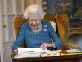 Queen Elizabeth II views a display of memorabilia from her Golden and Platinum Jubilees in the Oak Room at Windsor Castle on Feb. 4, 2022 in Windsor, England.