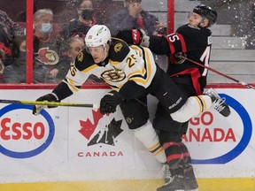 Boston Bruins defenceman Brandon Carlo is checked by Ottawa Senators left winger Parker Kelly last night. USA TODAY Sports
