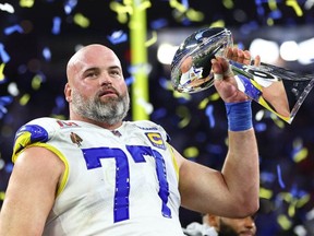 Los Angeles Rams offensive tackle Andrew Whitworth hoists the Lombardi Trophy after defeating the Cincinnati Bengals in Super Bowl LVI at SoFi Stadium.