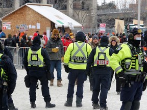 Police watch over a shack that was being used as a soup kitchen as truckers and their supporters continue to protest against the COVID-19 vaccine mandates in Ottawa, Ontario, Canada, February 6, 2022.