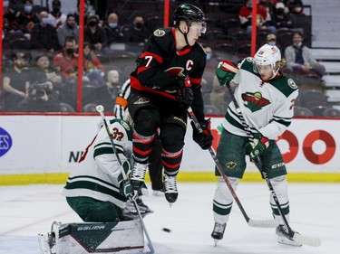 Ottawa Senators left wing Brady Tkachuk (7) jumps in front of Minnesota Wild goaltender Cam Talbot (33) as defenceman Jonas Brodin (25) defends during first-period action at the Canadian Tire Centre on Tuesday, Feb. 22, 2022.